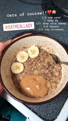 a bowl filled with oatmeal and bananas on top of a stovetop