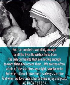 a woman holding a baby in her arms with a quote from mother teresa on it