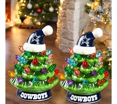 two nfl christmas trees with hats on top