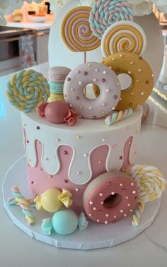 there is a cake decorated with donuts and lollipops