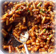 a bowl filled with pasta and meat sauce