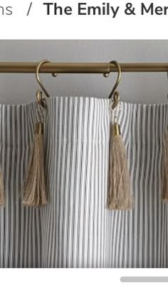 an image of curtains with tassels hanging from the rod and on the curtain