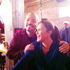 a man and woman sitting next to each other at a table