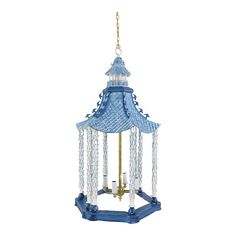 a blue and white chandelier hanging from a chain