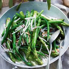 asparagus and onion salad in a bowl with spoons on the side, ready to be eaten