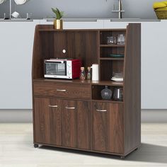 a microwave oven sitting on top of a wooden cabinet