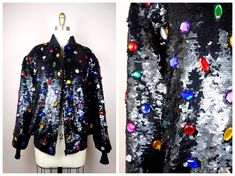 "This is an insanely GORGEOUS vintage piece of glam!! It's heavily embellished with black sequins and accented with multicolored jewels, all completely hand sewn. It's in PERFECT condition! This one is VERY well made!! Size SMALL Measurements: Bust - 40\" (while zipped) Waist - 26-36\" (unstretched and stretched) Length - 23\" Shoulders - 18\" Sleeves - 24\" Tag Size - 6 / Small (fits oversized) Size LARGE Measurements: Bust - 44\" (while zipped) Waist - 28-38\" (unstretched and stretched) Lengt Winter Party Outerwear With Rhinestones, Embellished Black Outerwear For Party Season, Black Embellished Outerwear For Party Season, Vintage Winter Outerwear With Sequins, Vintage Sequin Outerwear For Night Out, 80s Glam, Embroidered Roses, Evening Jackets, Beautiful Evening