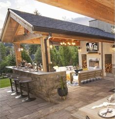 an outdoor kitchen and dining area is shown