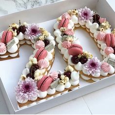 the number 20 is made out of cookies and decorated with pink, white and purple icing