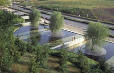 an aerial view of a park with water and trees