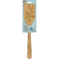 a wooden spatula shaped like a tree with leaves on it and a blue bird perched on the branch