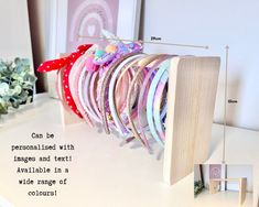 a bunch of different colored hair ties on a white table next to flowers and pictures