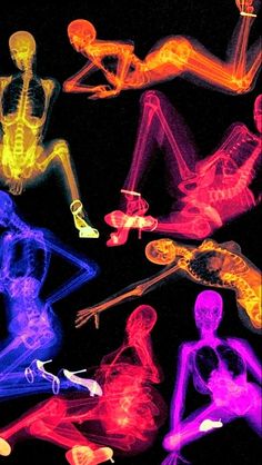 an image of some neon colored figures in the night time scene with one person laying on his stomach