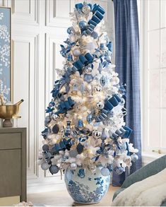 a blue and white christmas tree in a living room