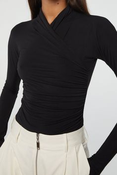 Description The Felix was inspired by our necessity for elegance, comfort, and versatility. It’s cut from a luxuriously soft micro-Modal jersey and features a fitted bodice with ruching at the waist, a high neckline, and is finished with merrow stitching down the back seam and hem. Wear it as a streamlined base to boxy Fitted Long Sleeve Top With Ruched Sides, Elegant Ruched Tops For Layering, Fitted Tops With Ruched Sides For Fall, Elastane Ruched Tops For Night Out, Elegant Spring Top With Ruched Sides, Chic High Neck Ruched Tops, Chic Ruched High Neck Tops, Elegant Fitted Elastane Top, Elegant Ruched Foldover Top