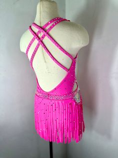 a pink dress with fringes and beads on it