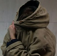 a person with their head in the back of a jacket