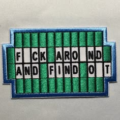 a patch with the words f k aro and find out in white letters on it