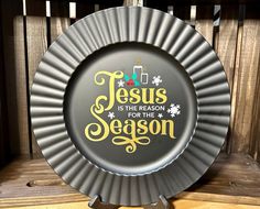 a plate with the words jesus is the reason for the season on it sitting on a shelf