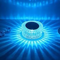 two blue lights shining in the middle of a room with ice cubes on the floor