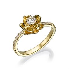 a yellow gold ring with a flower and diamonds on the band, set in 18k yellow gold