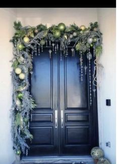 the front door is decorated with ornaments and greenery