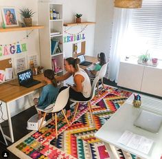 two people sitting at a desk in an office