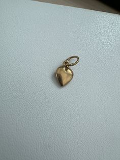 14k Vintage Heart Charm This 14k Vintage Heart Charm is a delicate and beautiful addition to any jewelry collection. The charm measures 13.6mm x 6.1mm and weighs 0.36 grams. This piece, like all our jewelry, is a unique find—once it's gone, it's gone—unlikely to be sourced again! Choosing this piece is a win-win: You'll stand out from the crowd & help the environment by shopping sustainably! Why You'll Love It: Sweet Design: The heart shape adds a loving and sweet touch to your look. High-Qualit Elegant 14k Gold Heart Charm, Vintage Charm Heart-shaped Yellow Gold Jewelry, Yellow Gold Heart Jewelry With Vintage Charm, Minimalist 14k Gold Pendant Charm, Gold Vintage Charm Heart Pendant, Gold Heart Pendant Vintage Charm, Yellow Gold Heart Charm Pendant, Heart-shaped Yellow Gold Charms For Anniversary, Yellow Gold Heart Charms For Anniversary