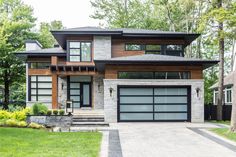 a modern house in the suburbs of toronto, canada with stone and wood sidings