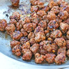 meatballs are being cooked in a frying pan