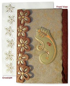 an intricately decorated greeting card with gold and white embellishments on it