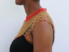 AMAZI Beaded cape necklace made using 100% fine beads.

Color: Red and Gold

Closure: hook

Length: 16 inches long

Material: Beads

It is made on order hence it's ready to ship within 1-3 days.

Shipping cost is calculated during checkout.

DHL Express shipping that takes  3-5 days to be delivered Elegant Festival Beaded Necklaces With Gold Beads, Elegant Gold Beaded Festival Necklaces, Elegant Bead Cap Necklaces For Festivals, Elegant Necklace With Bead Caps For Festivals, Elegant Festival Necklace With Bead Caps, Colorful Beads Choker Bib Necklaces, Elegant Large Beads Bib Necklace For Festivals, Elegant Large Bead Choker For Festivals, Elegant Festival Choker With Large Beads