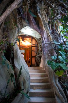 an entrance to a cave with stairs leading up into it