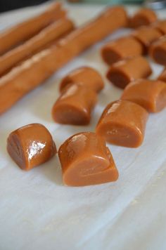 several pieces of caramel sit on a cutting board