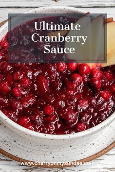 cranberry sauce in a white bowl with an apple on top and the words ultimate cranberry sauce above it