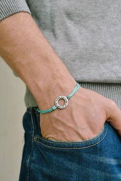 Turquoise bracelet for men - cord bracelet with a silver plated circle charm with the sentence 'Life is what you make of it'. The cord is turquoise and made of waxed cotton and the charm is silver plated. Closure: clasp. You can request a different cord color from the colors shown in the last picture. The bracelet is 7 1/2 inches long (19cm). If you would like a different length let us know and we will make it for you. This bracelet is great as a gift for a man or a boy. All of our jewelry comes Bts Bracelet, Paw Print Bracelet, Pride Bracelet, Pandora's Box, Men Birthday, Feather Bracelet, Stamped Bracelet, Moms Bracelet, Mens Bracelet Silver