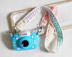 a blue camera sitting on top of a white mat