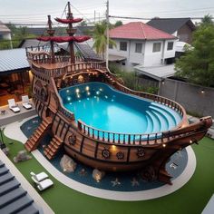 an above ground swimming pool in the middle of a yard with a pirate ship on it