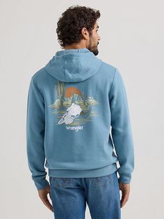 BORN IN THE USA Nothing’s more American than a great pair of blue jeans. Celebrating the legacy we’ve built since 1947, our men’s desert cacti Wrangler® logo pullover hoodie makes it easy to keep warm and snug as cooler weather arrives. It’s crafted from a cotton blend for nonstop comfort in the seasons ahead. It features a western-inspired graphic with the Wrangler logo set against a desert backdrop. Wrangler Hoodie, Desert Backdrop, Cute Country Outfits, Wrangler Shirts, Western Outfits Women, Hoodies Men Pullover, Desert Cactus, Cute N Country, Logo Set