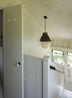 an open door leading to a bedroom with white walls