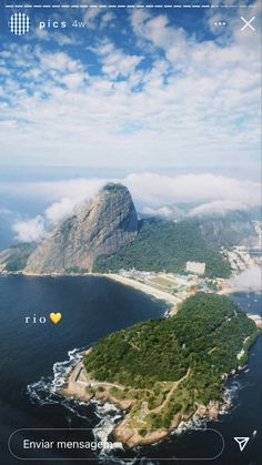 an island in the middle of water with clouds above it and a yellow heart on top