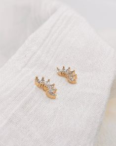 Marquise crystals fanned out for the perfect ear climber / stud duo. Wear these sparkly studs with any outfit to dress it up. Model is shown pairing it with our classic huggies! Details: 11MM X 5MM. Gold filled, nickel free, tarnish free, hypoallergenic, waterproof. Processing time is 2-5 days in our Santa Rosa Studio. Each order is shipped via USPS. Marquise Cut Diamond Eyes Earrings Gift, Marquise Cut Earrings With Diamond Eyes, Dainty Gold Marquise Earrings, Gift Marquise Diamond Earrings For Pierced Ears, Gold Marquise Earrings For Party, Marquise Gold Earrings With Diamond Eyes, Marquise Cubic Zirconia Dainty Earrings, Dainty Marquise Cubic Zirconia Earrings, Ear Climber