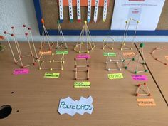 a wooden table topped with lots of pins and magnets next to a bulletin board