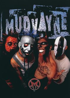 three men with masks on their faces posing for a photo in front of a sign that says mudaye