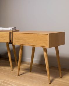 two wooden nightstands with one drawer open and the other closed, on a hardwood floor