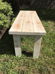 a wooden bench sitting in the grass