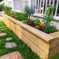 a wooden planter filled with lots of flowers