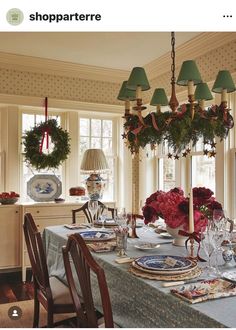 a dining room table set for christmas dinner