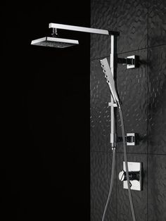 a shower head with thermostaer and handset in black and white photo