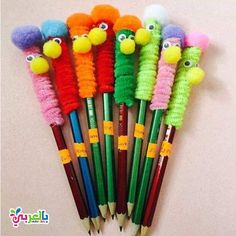 a group of colorful pencils with different colored animals on them sitting next to each other